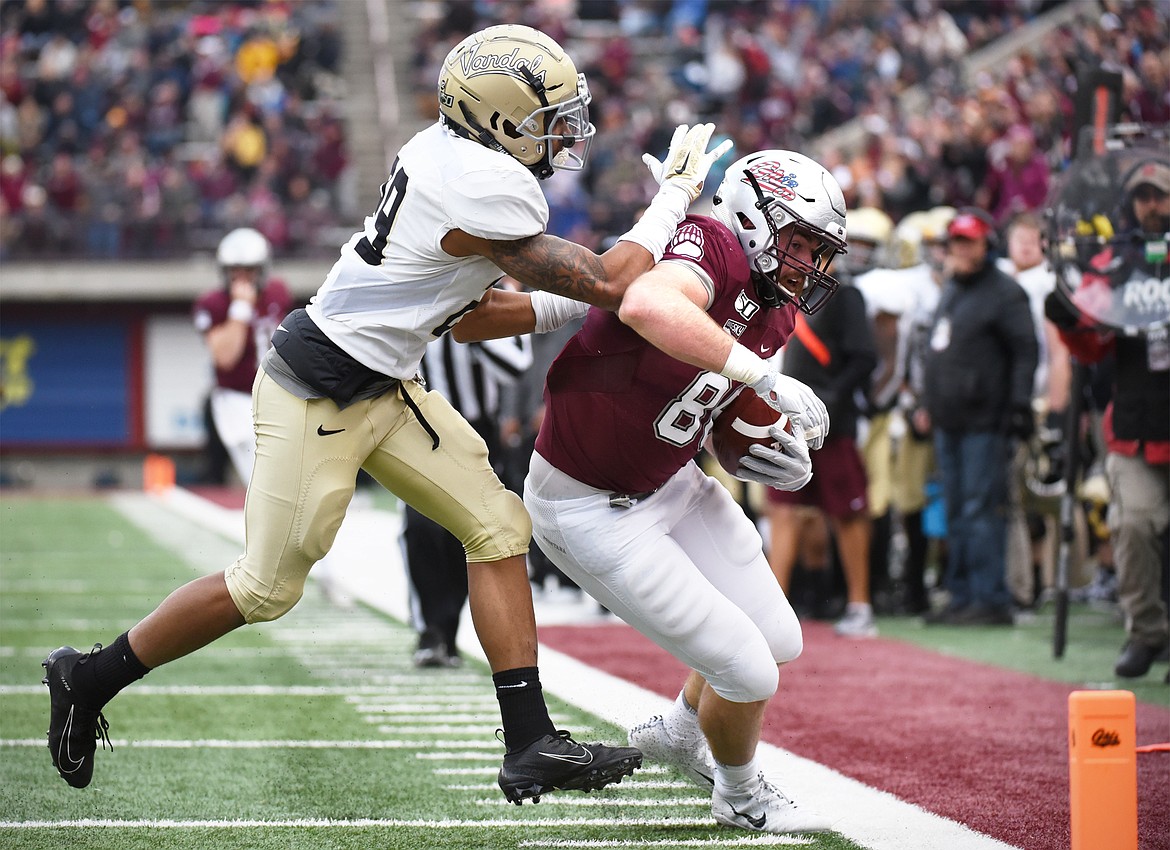 Montana tight end Colin Bingham (88) is tackled out of bounds by Idaho defensive back Sedrick Thomas (29) after a 15-yard reception in the fourth quarter at Washington-Grizzly Stadium on Saturday. (Casey Kreider/Daily Inter Lake)