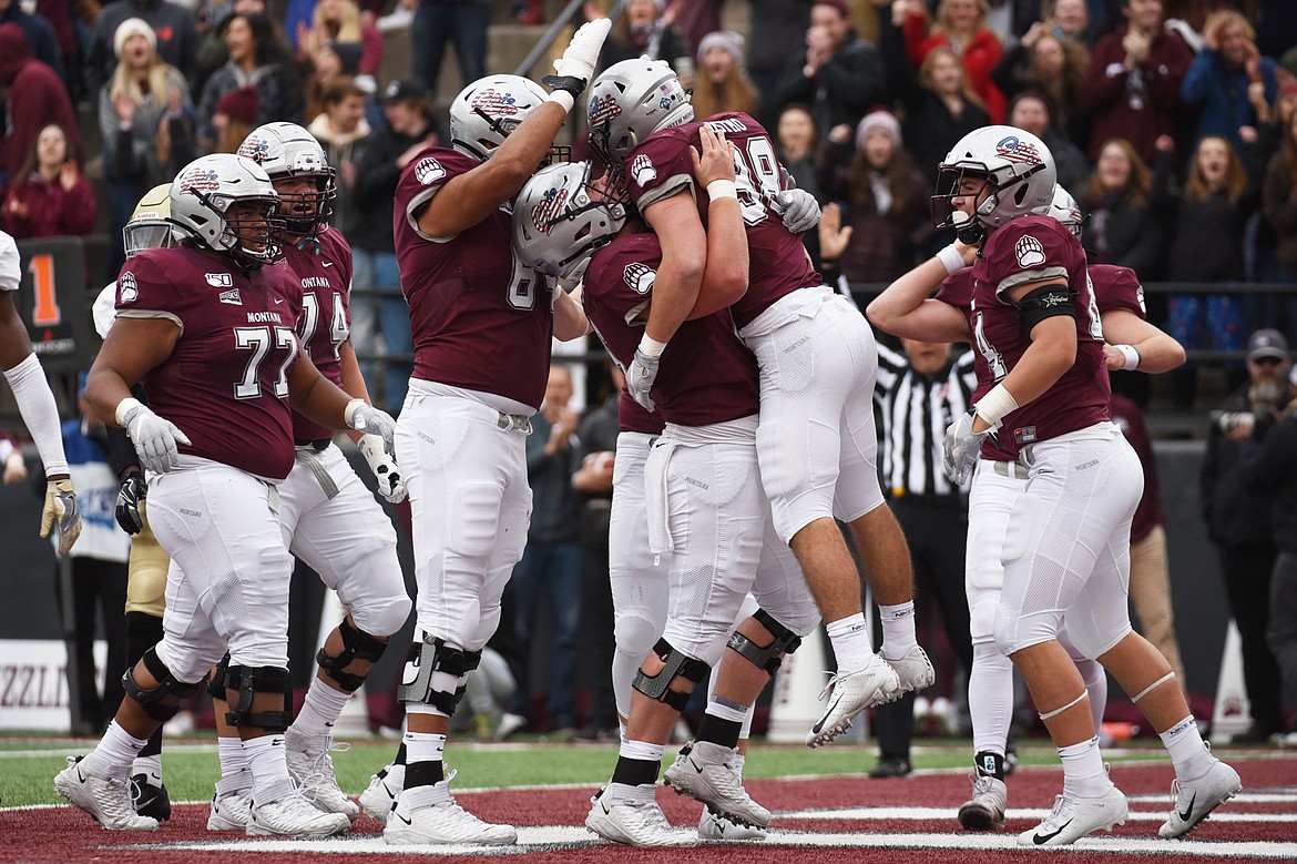 Montana running back Nick Ostmo (38) celebrates with teammates after a first-half touchdown run against Idaho at Washington-Grizzly Stadium on Saturday. (Casey Kreider/Daily Inter Lake)