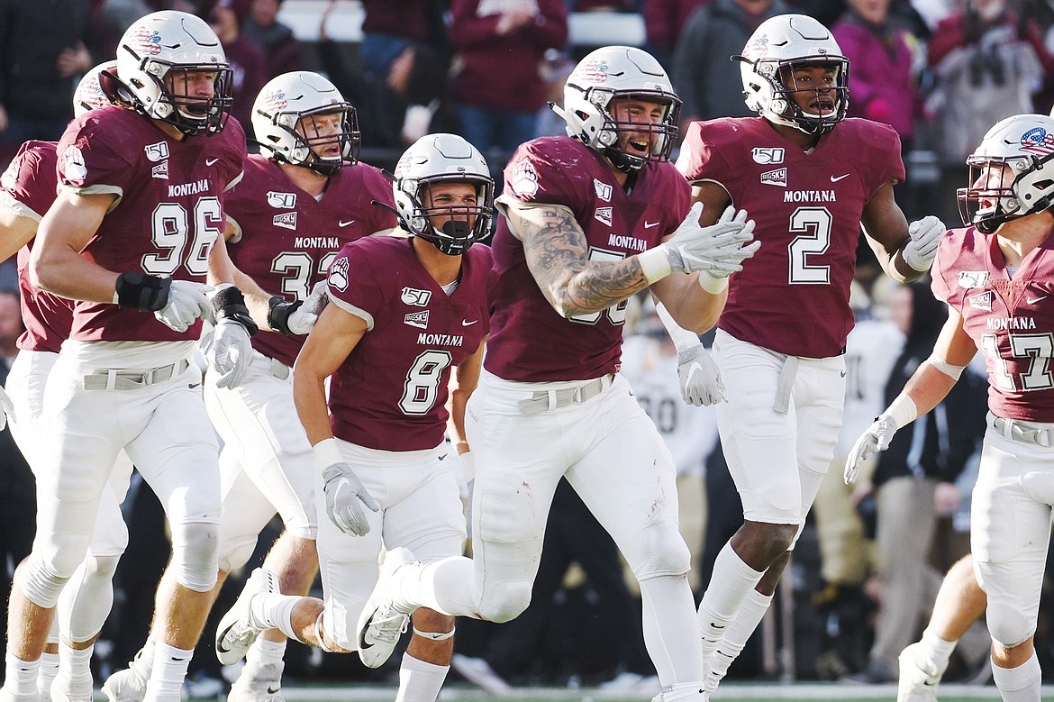 Montana defensive end Joe Babros (56) celebrates with teammates after his third-quarter interception against Idaho at Washington-Grizzly Stadium on Saturday. (Casey Kreider/Daily Inter Lake)