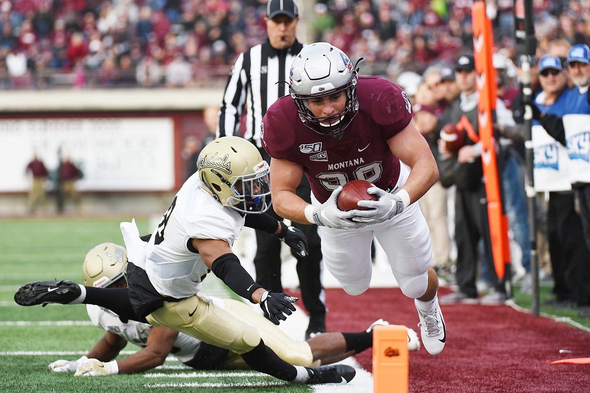 Montana running back Nick Ostmo (38) dives for the end zone on an 11-yard reception in the third quarter against Idaho at Washington-Grizzly Stadium on Saturday. Ostmo stepped out of bounds at the 5-yard line but ran in a 1-yard touchdown later in the drive. (Casey Kreider/Daily Inter Lake)