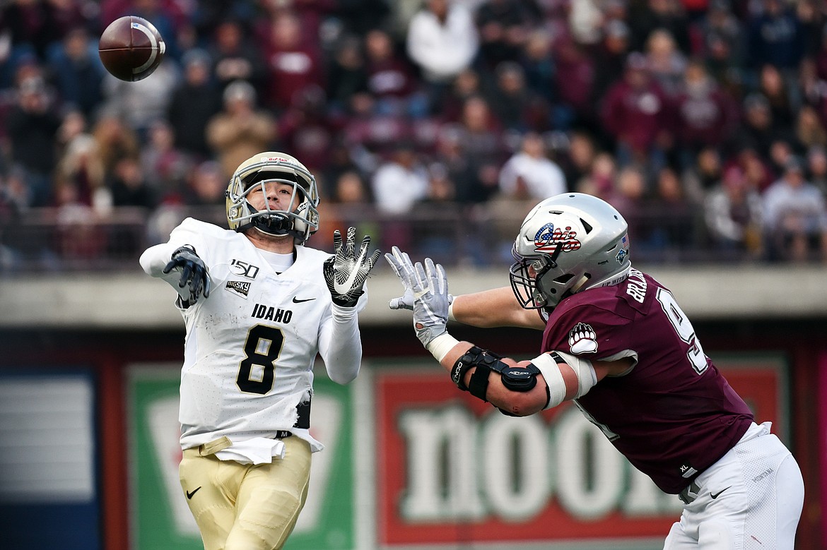 Idaho quarterback Mason Petrino (8) throws under pressure from Montana defensive end Braydon Deming (93) in the fourth quarter at Washington-Grizzly Stadium on Saturday. (Casey Kreider/Daily Inter Lake)