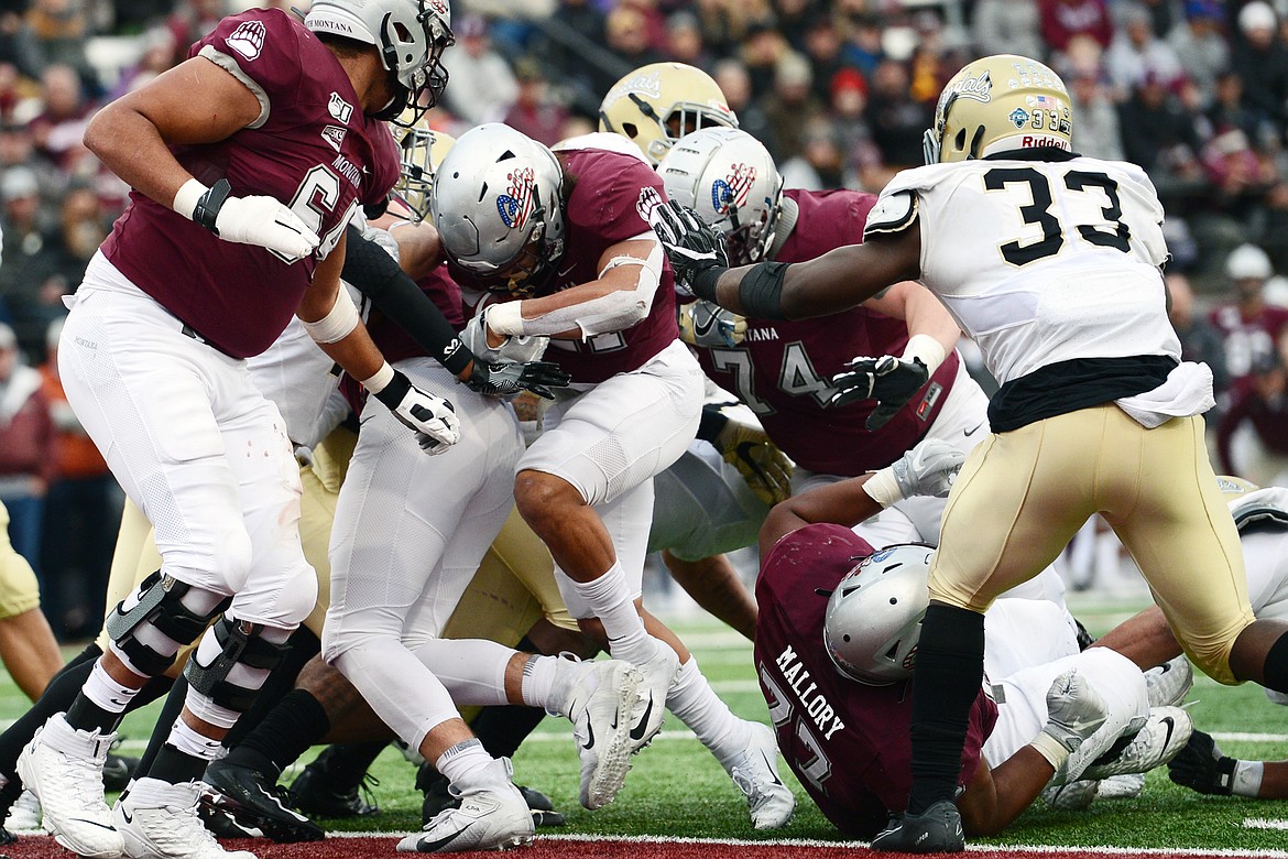 Montana Grizzlies running back Marcus Knight (21) powers into the end zone on a 2-yard touchdown run in the fourth quarter against the Idaho Vandals at Washington-Grizzly Stadium on Saturday. (Casey Kreider/Daily Inter Lake)
