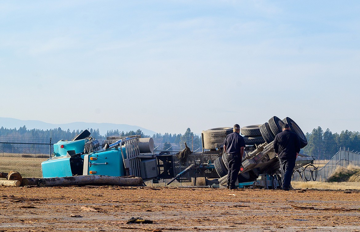 Witnesses look over the scene of a fatal accident near Glacier Park International Airport Friday afternoon.