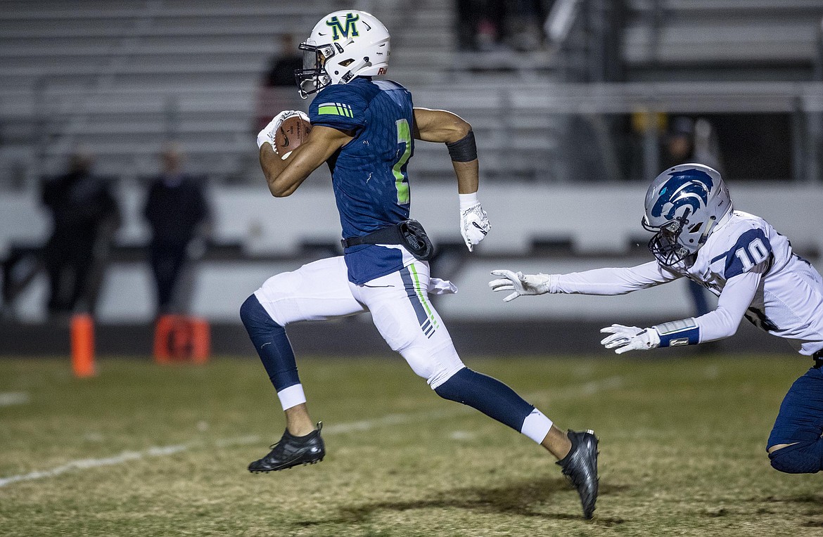 DARIN OSWALD/The Idaho Statesman
Mountain View wide receiver K.J. Lynch runs the distance chased by Lake City senior Logan Jeanselme after catching a pass in the first quarter Friday in Meridian. The Mavericks ran away with the first-round 5A state playoff win, beating the Timberwolves 58-0.