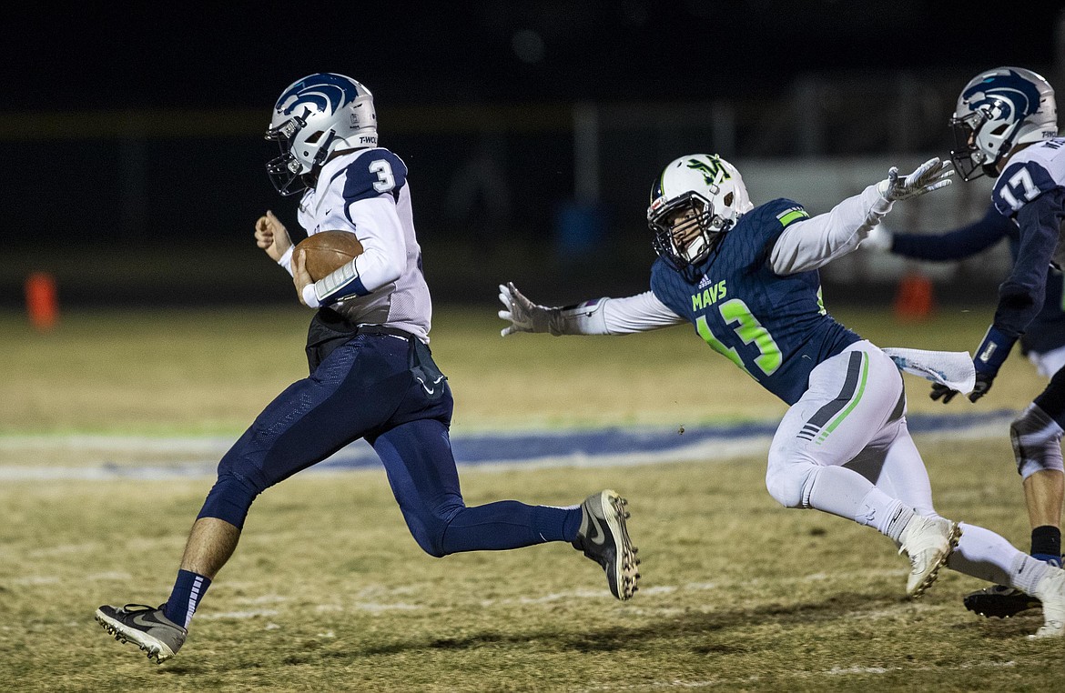 DARIN OSWALD/The Idaho Statesman
Lake City quarterback Josiah Weaver finds funning room on a keeper defended by Mountain View&#146;s Kodee Chiles in the first round of the 5A state playoffs Friday in Meridian.