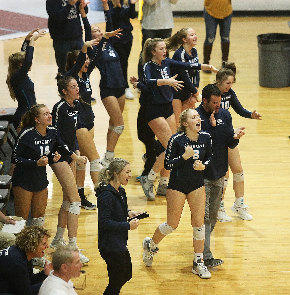 The Lake City High bench celebrates a point in an Idaho State 5A tournament volleyball match against Eagle Friday at Post Falls High. (LOREN BENOIT/Press)