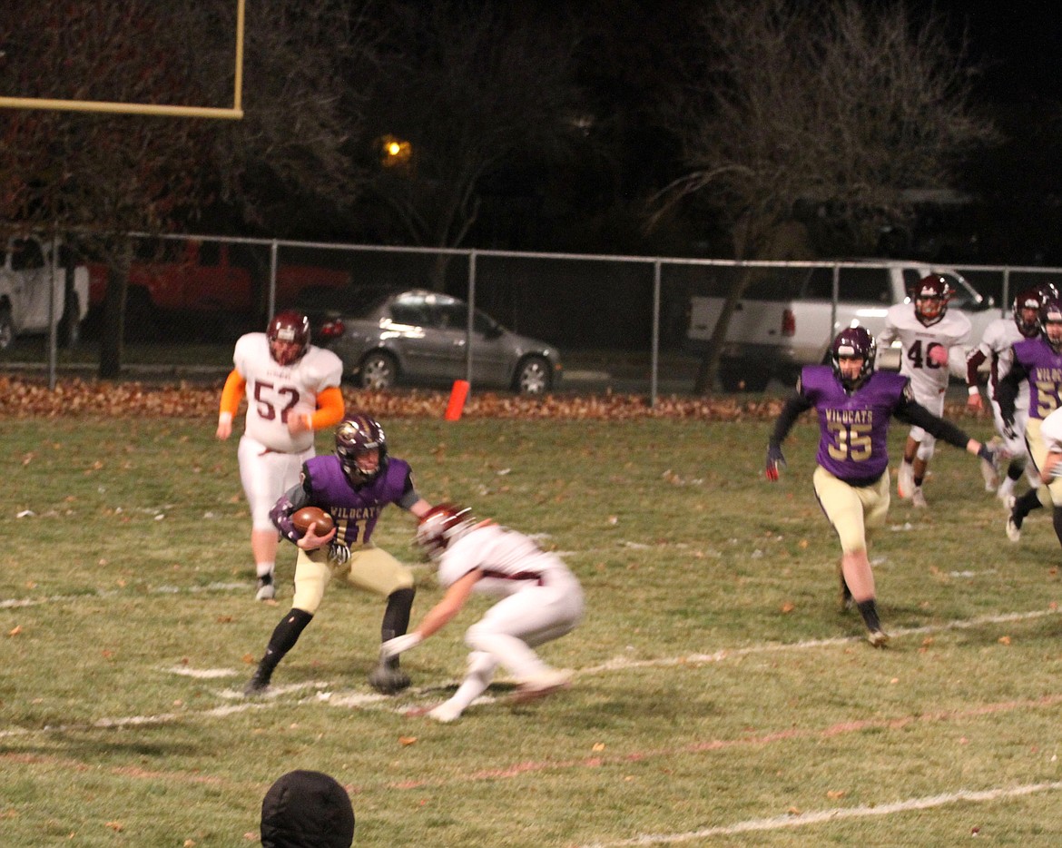 Kellogg quarterback Brandon Miller sends a Teton defender to the ground during the Wildcats&#146; loss to the Redskins. 

Photo by RAD GROTH