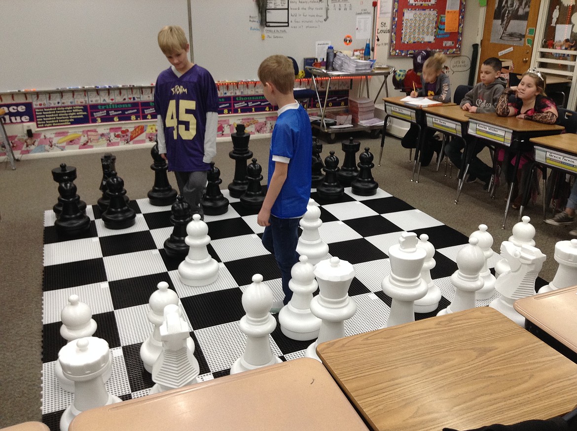 Courtesy photo
Fourth-grade students at Pinehurst Elementary School work on their strategic thinking with a game of giant chess, which was part of a grant from Figpickels Toy Emporium.