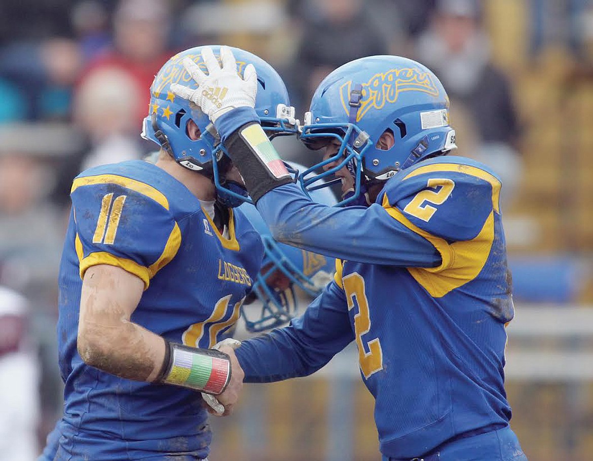 Chandler Bower, left, gets congrats from Colton Halvorson for his interception with 1:25 left in fourth quarter vs. Butte Central Saturday. Loggers over Maroons 49-28. (Paul Sievers/The Western News)