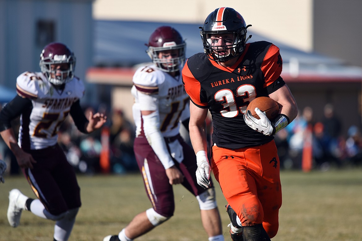 Eureka running back Jake Kindel (33) picks up yardage on a run in the second quarter against Baker at Lincoln County High School in Eureka on Saturday. (Casey Kreider/Daily Inter Lake)