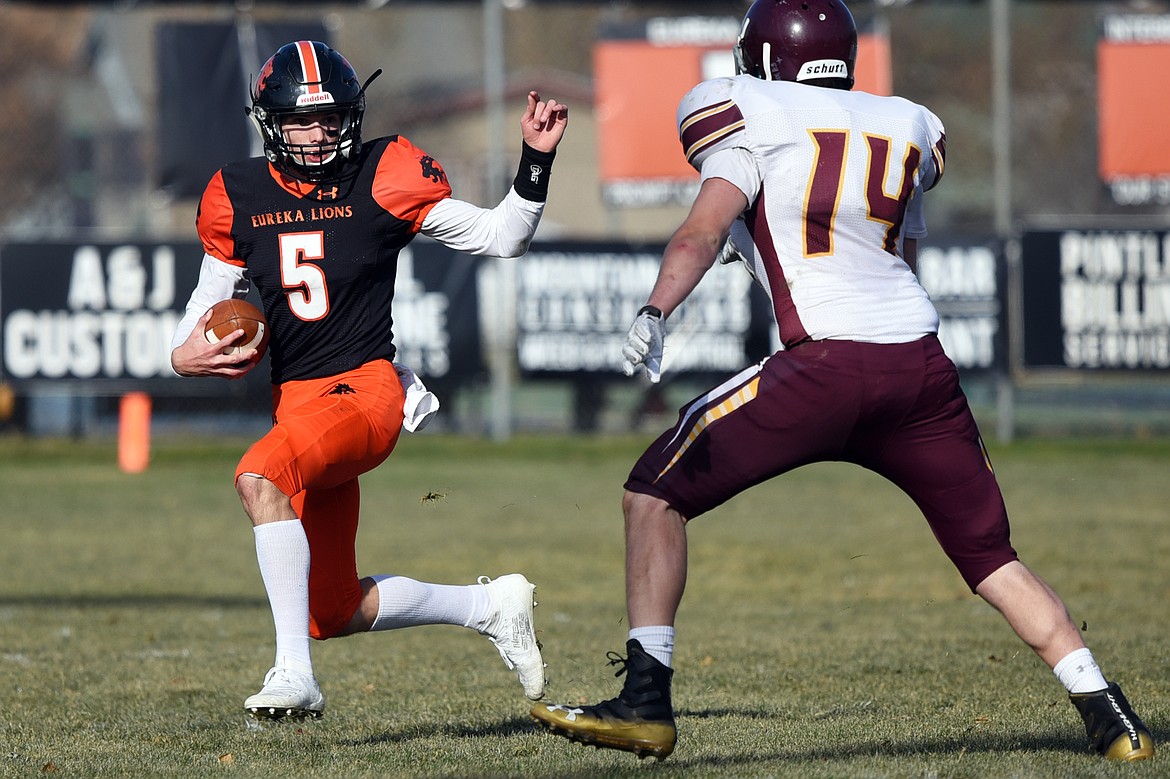 Eureka quarterback Hank Dunn (5) scrambles for a gain in the second quarter against Baker at Lincoln County High School in Eureka on Saturday. (Casey Kreider/Daily Inter Lake)