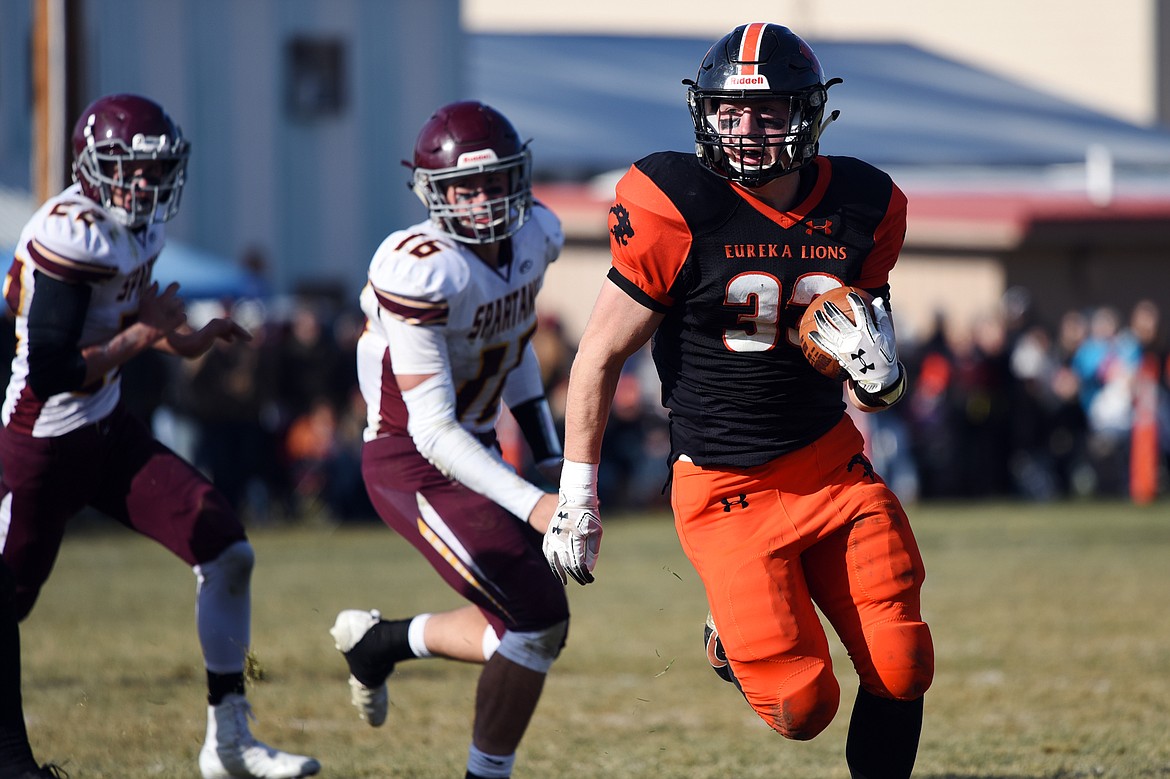 Eureka running back Jake Kindel (33) picks up yardage on a run in the second quarter against Baker at Lincoln County High School in Eureka on Saturday. (Casey Kreider/Daily Inter Lake)