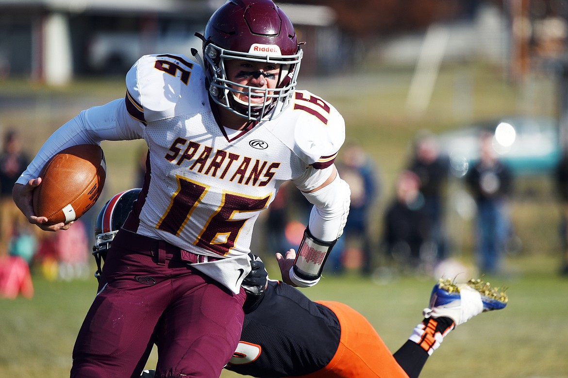 Baker quarterback Riley O'Donnell (16) looks for room to run against Eureka in the first quarter at Lincoln County High School in Eureka on Saturday. (Casey Kreider/Daily Inter Lake)