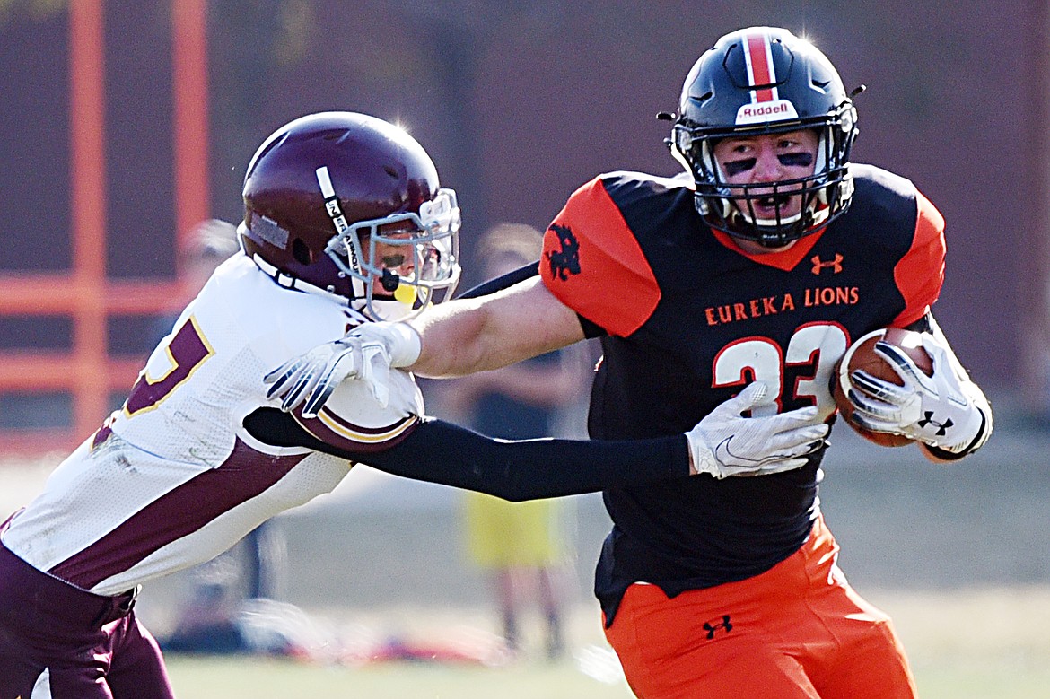 Eureka running back Jake Kindel (33) is brought down by Baker's Konnor Flint (2) on a run in the first quarter at Lincoln County High School in Eureka on Saturday. (Casey Kreider/Daily Inter Lake)