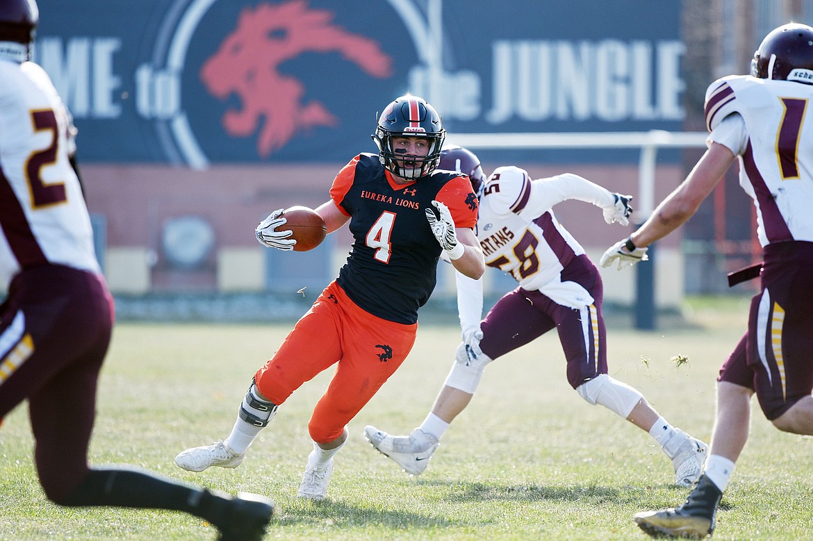 Eureka running back Chet McCully (4) bounces a run to the outside in the first quarter against Baker at Lincoln County High School in Eureka on Saturday. (Casey Kreider/Daily Inter Lake)
