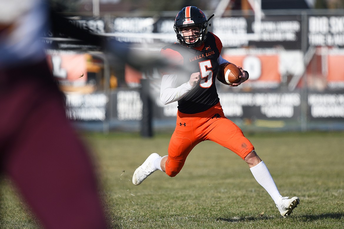 Eureka quarterback Hank Dunn (5) scrambles for a gain in the second quarter against Baker at Lincoln County High School in Eureka on Saturday. (Casey Kreider/Daily Inter Lake)