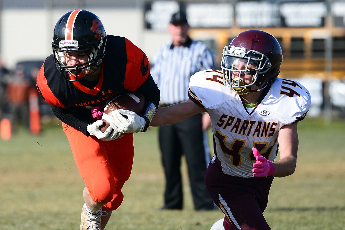 Eureka linebacker Corbin Hurst (12) can't hang on to an interception in front of Baker wide receiver Teight Madler (44) in the second quarter at Lincoln County High School in Eureka on Saturday. (Casey Kreider/Daily Inter Lake)