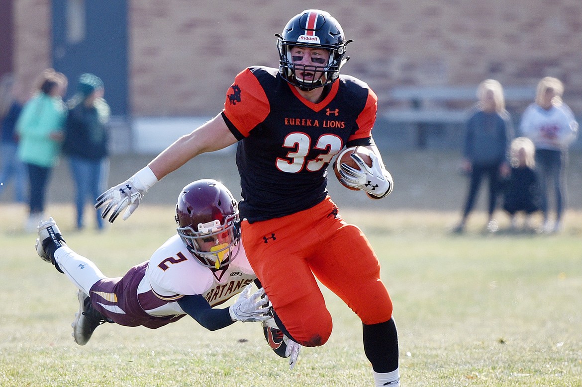 Eureka running back Jake Kindel (33) is brought down by Baker's Konnor Flint (2) on a run in the first quarter at Lincoln County High School in Eureka on Saturday. (Casey Kreider/Daily Inter Lake)