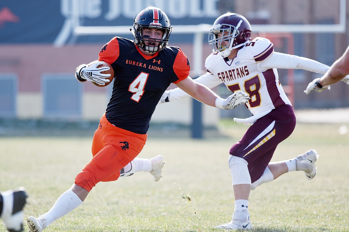 Eureka running back Chet McCully (4) bounces a run to the outside in the first quarter against Baker at Lincoln County High School in Eureka on Saturday. (Casey Kreider/Daily Inter Lake)