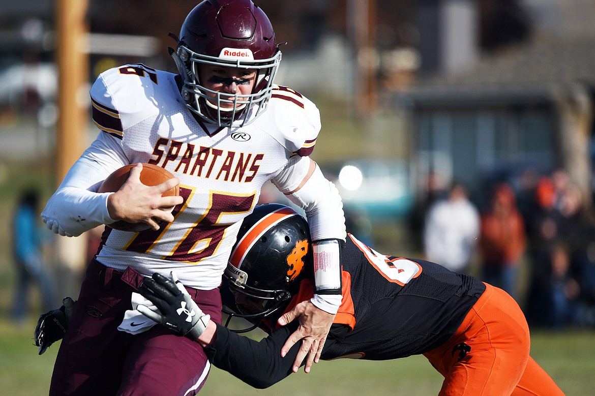 Baker quarterback Riley O'Donnell (16) looks for room to run against Eureka in the first quarter at Lincoln County High School in Eureka on Saturday. (Casey Kreider/Daily Inter Lake)