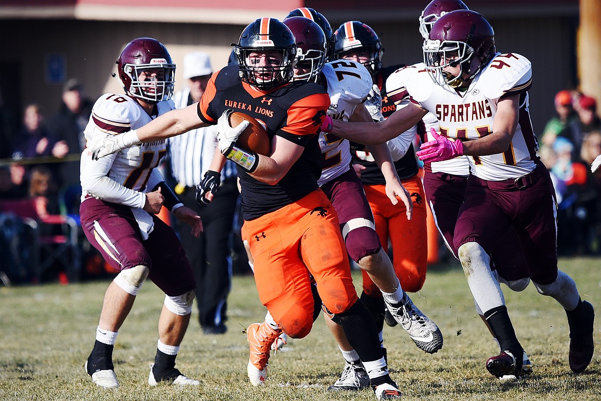 Eureka running back Jake Kindel (33) picks up yardage on a run in the second quarter against Baker at Lincoln County High School in Eureka on Saturday. (Casey Kreider/Daily Inter Lake)