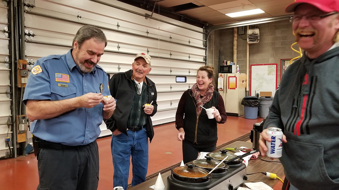 Photo by MANDI BATEMAN
Len Pine samples Tom Charey&#146;s &#147;Hell&#148; chili, while people watch his reaction to the heat.