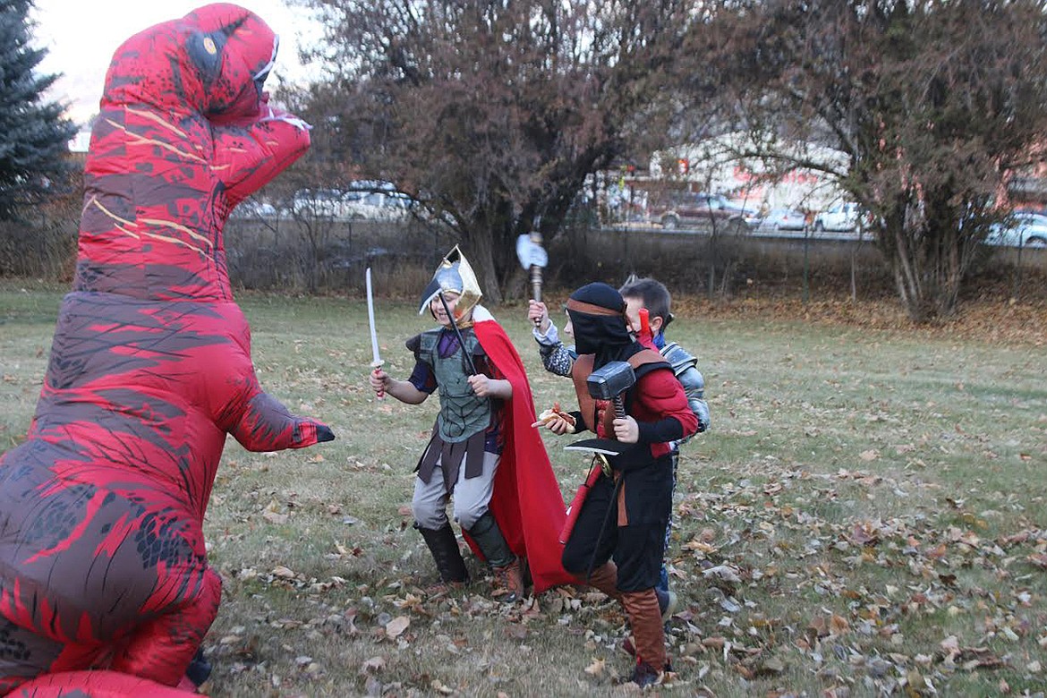 Plains Halloweeners take on T-Rex during last week&#146;s festivities. (Lisa Larson/Valley Press)