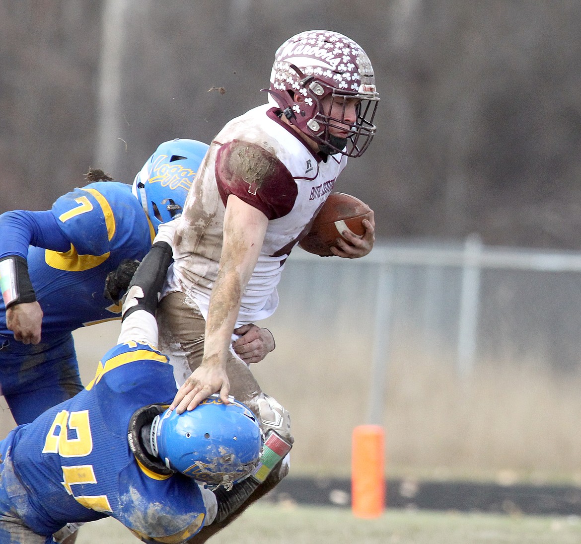 Dave Patterson and Hunter Hoover go high and low to tackle Butte Central&#146;s Thomas McGree in the third quarter of the Class A football playoff game Nov. 1. Although the Maroons kept the game tight in the first half, the Loggers, led by quarterback Jay Beagle and running back Dawson Young, both juniors, pulled away for a 49-28 victory. (Paul Sievers/The Western News)