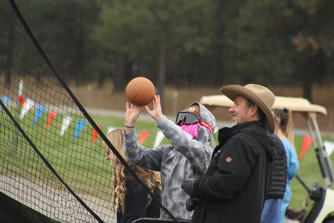 JAMES SOUTHWELL attemptting to shoot a basket while wearing the potent &#147;Beer Goggles,&#148; while being supervised by Blaine Blackstone last Thursday. (John Dowd/ Clark Fork Valley Press)