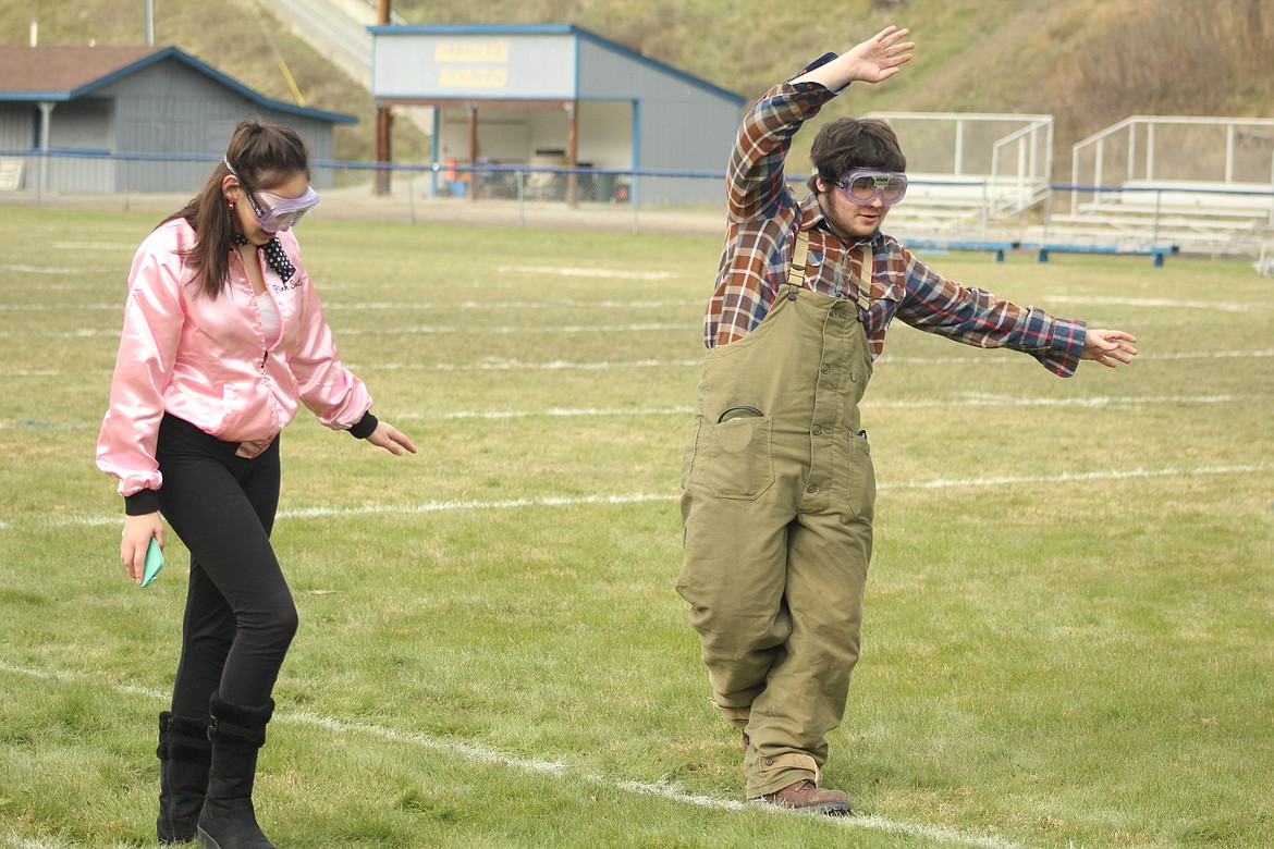 JASMIN PEARSON and Josh Elder walking the line while wearing the inebriation simulating goggles to experience a realistic sobriety test. (John Dowd/ Clark Fork Valley Press)
