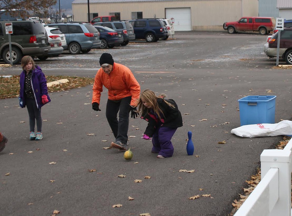 Marge Kohm with Graycee and Emmalee going bowling at Plains School Harvest Festival on Halloween. (Lisa Larson/Valley Press)