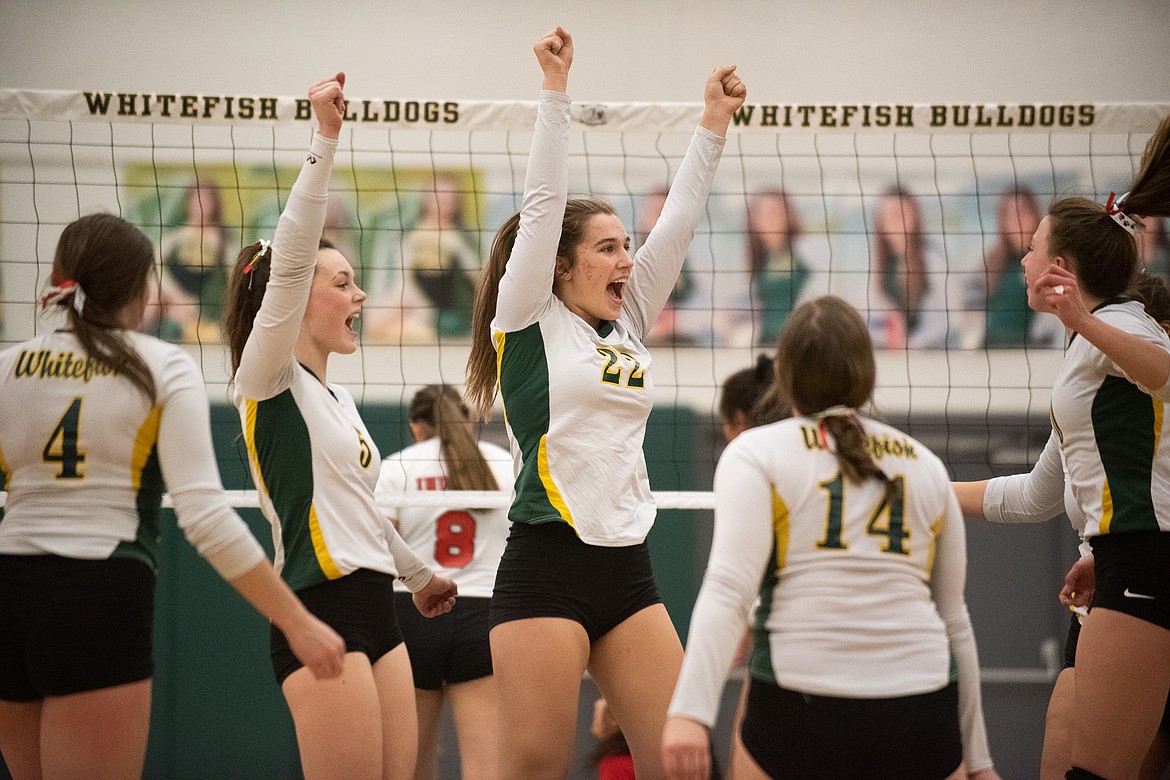 The Lady Dogs celebrate during Monday's play-in win over Browning. (Daniel McKay/Whitefish Pilot)