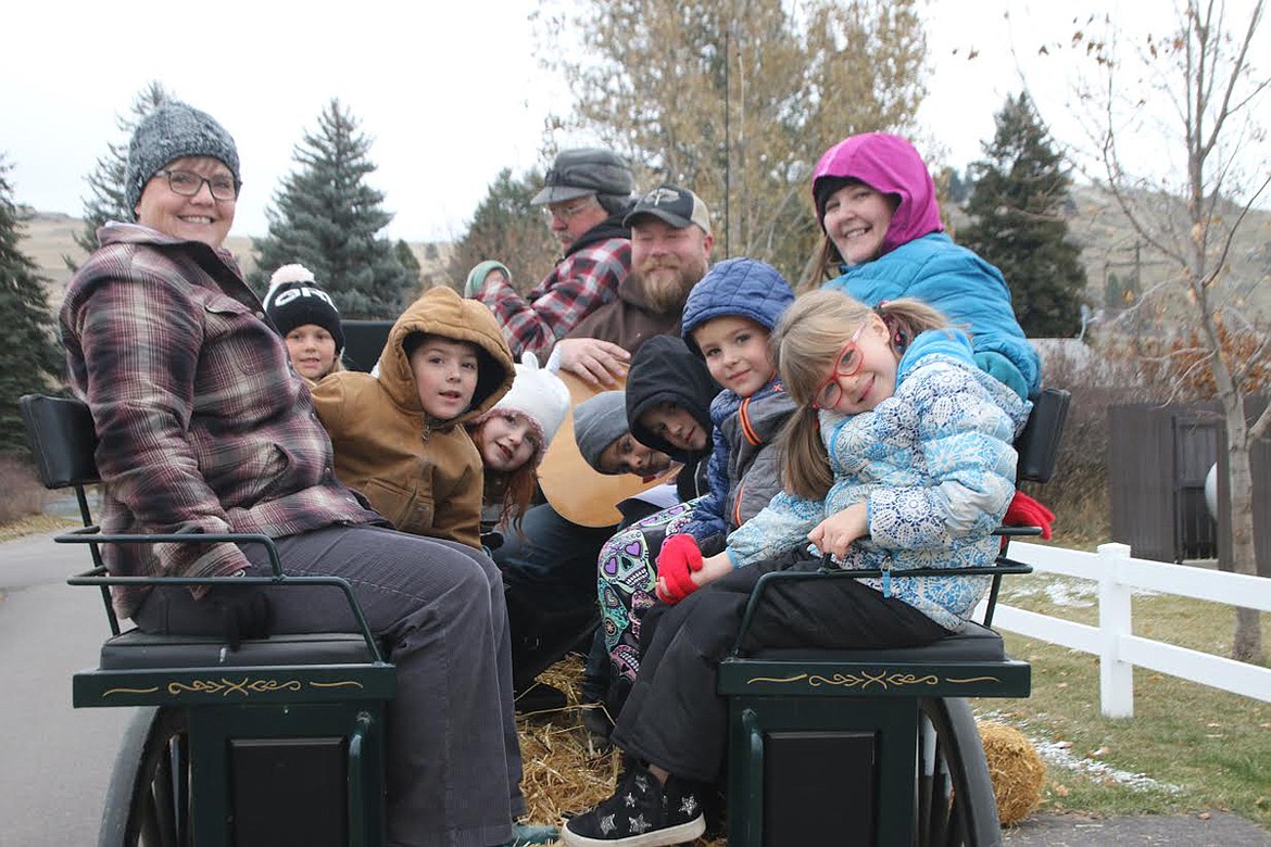 Mrs. Montgomery, Warren Wickam, Joel the Singing Cowboy, Lesley Riffle and the kids take a wagon ride on Halloween at Plains School Harvest Festival. (Lisa Larson/Valley Press)