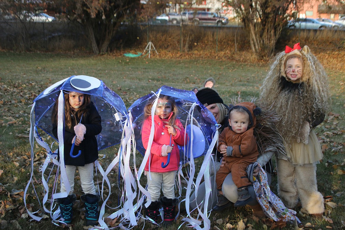 Here are the Plains Lions Club Halloween Costume Contest winners. From left, are third-place finisher jellyfish Gracelynn Larsen and Clara Larsen; second-place finisher porcupine Maverick French (with his mom Melissa French), and first place winner cowardly lion Kendell Spurr. (Lisa Larson/Valley Press)