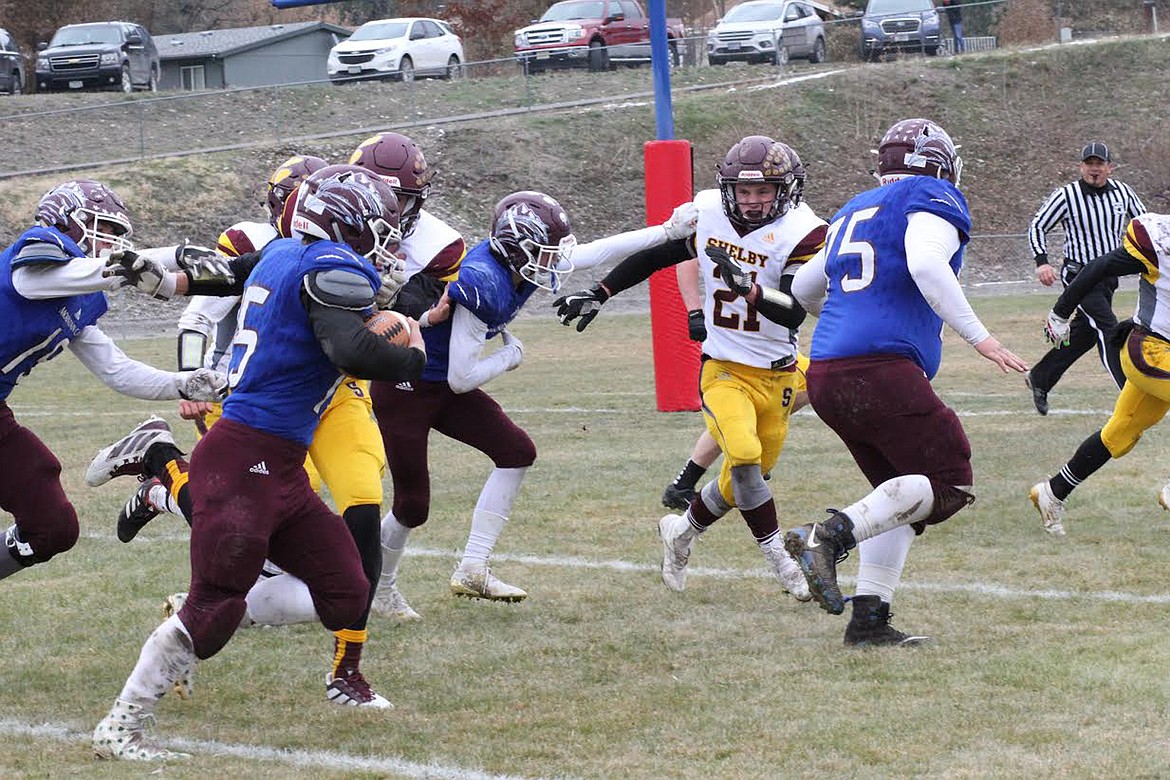 Clark Fork Mountain Cats lineman Jacob Lapinski (75) leads the way on a TD run by Trey Green (15) Saturday against Shelby. (Chuck Bandel/Mineral Independent)