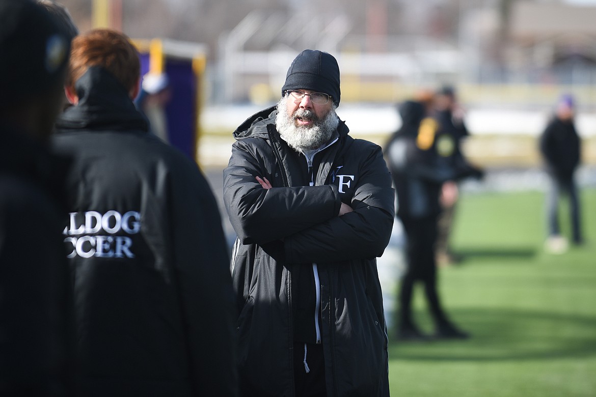 Head coach John Lacey consults with his assistant coaches during the Bulldogs&#146; 4-0 state title win over Laurel . (Daniel McKay/Whitefish Pilot)