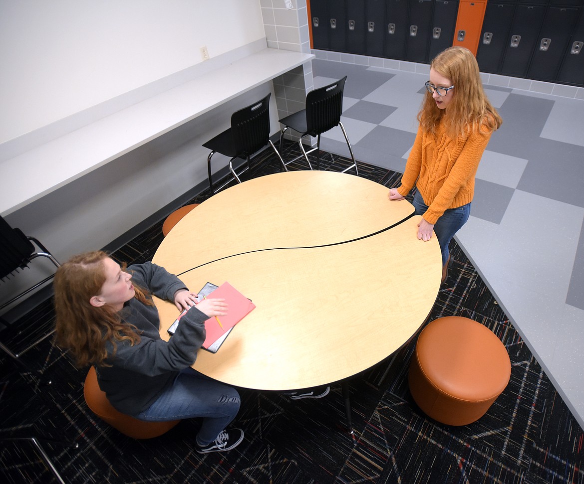 Shelbie Guckenberg, a junior, gives sophomore Kadence Johnson her notes on Johnson&#146;s dramatic interpretation at Flathead High School. The students are part of the speech and debate team and were practicing on Monday afternoon for their upcoming competition.
(Brenda Ahearn/Daily Inter Lake)