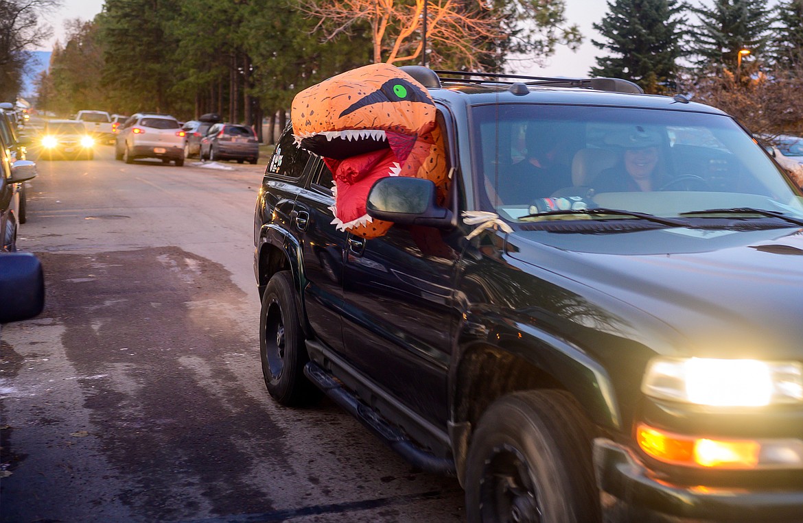 This year inflatable dinosaur costumes were popular, here a T-Rex arrives at the Veteran Home.