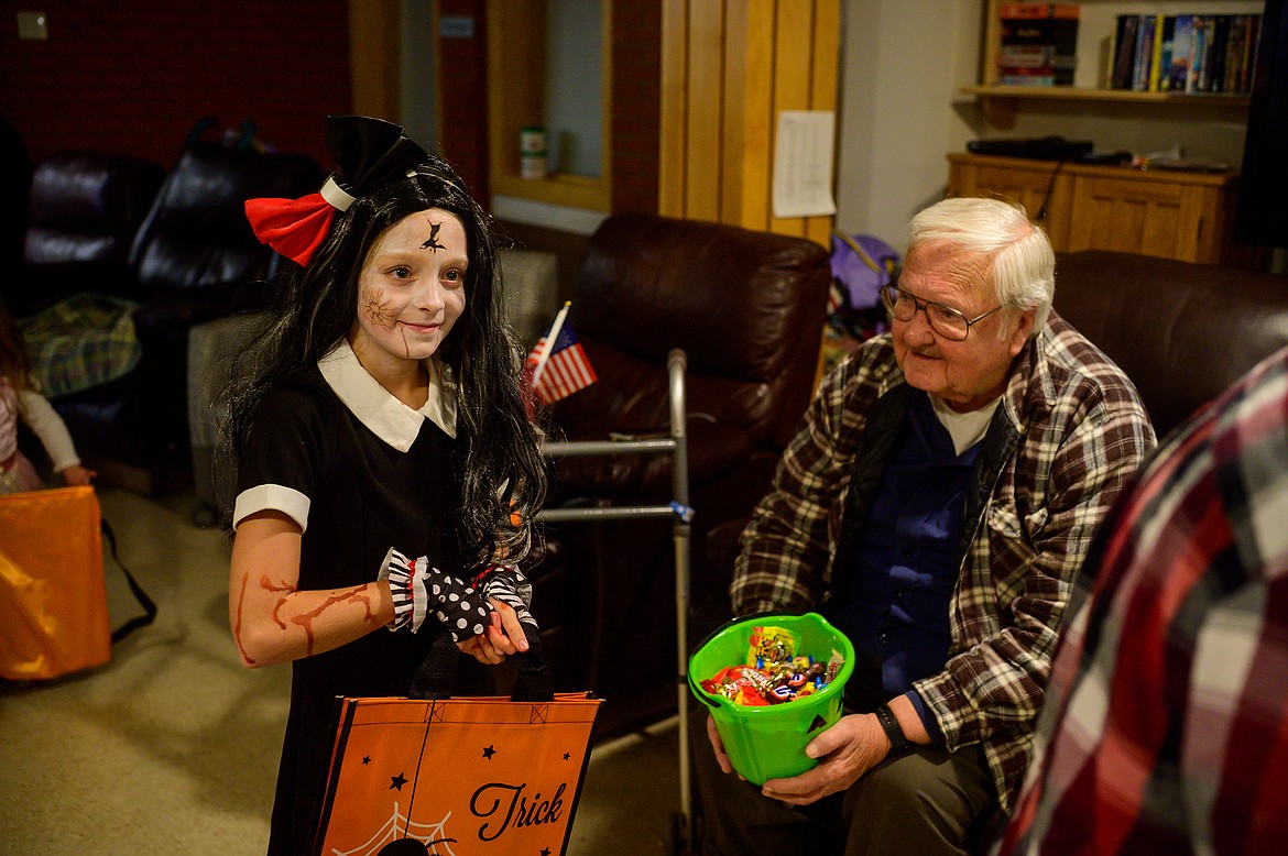 Taylin Pieterick, a spooky doll, waits in line for treats at the Montana Veterans Home.