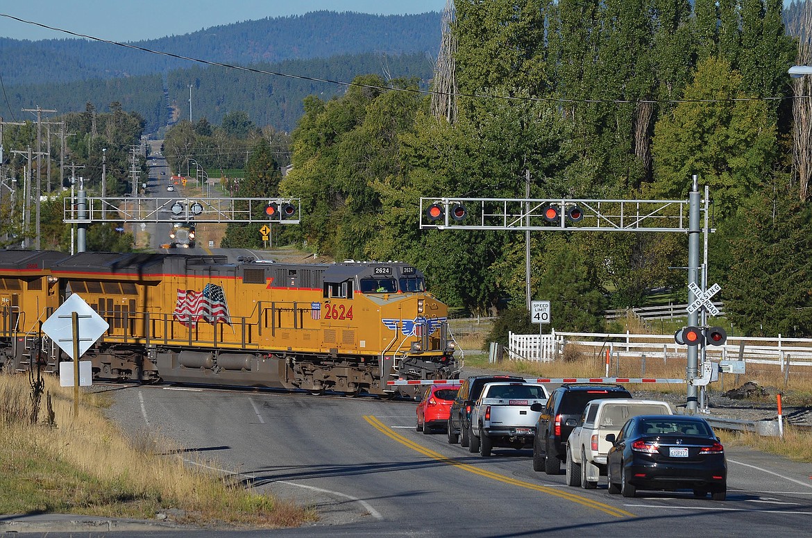 A Union Pacific train crosses Prairie Avenue near the Idaho Road intersection in Post Falls, where residential growth has surrounded both sides of the once-rural rail line. BRUCE KELLY/Courtesy