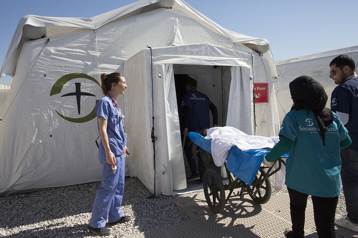 A wounded patient is brought into the emergency field hospital in Iraq where Ayad Saleh worked in security. (Courtesy of Samaritan&#146;s Purse)