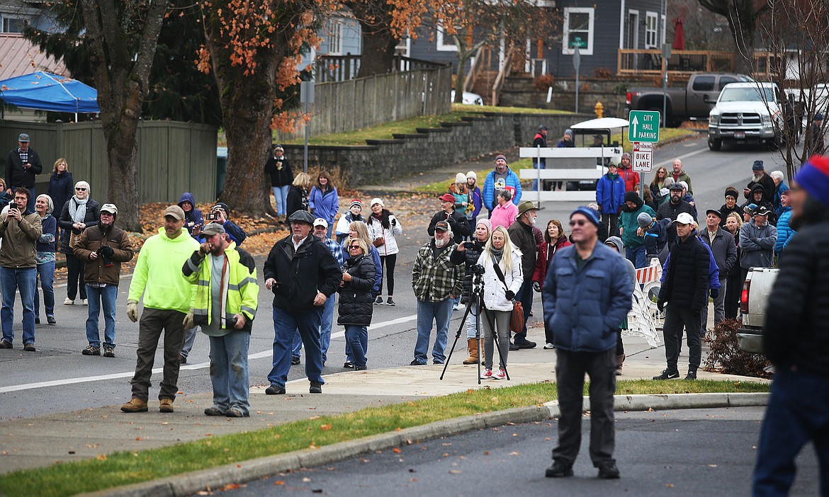 Spectators watch the J.C. White House move down 8th Street during its move from Sherman Avenue to Tubbs Hill on Saturday. (LOREN BENOIT/Press)