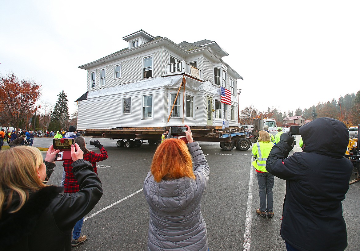 Spectators take pictures and video in the parking lot next to City Hall. (LOREN BENOIT/Press)