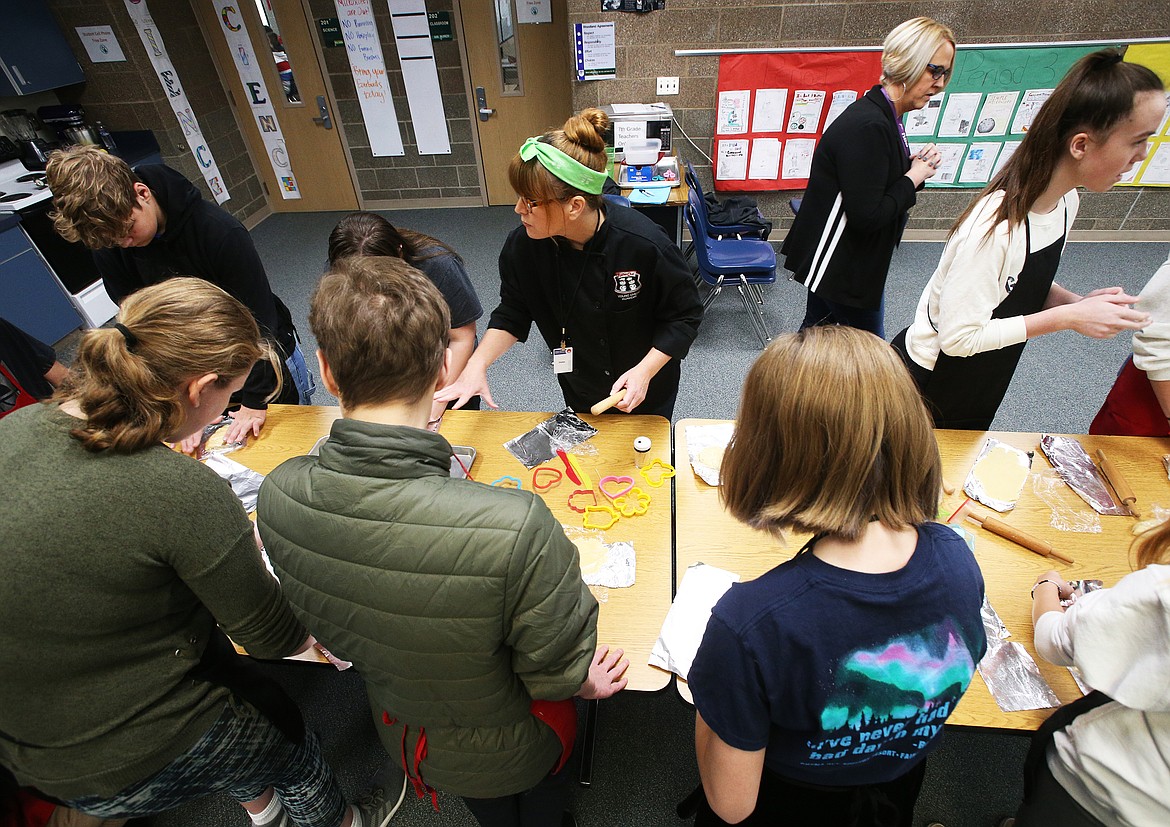 Amber Garcia, who co-owns Young Chefs Academy in Hayden, helps Woodland Middle School students prep Christmas cookies during a Teen Living course Thursday. (LOREN BENOIT/Press)