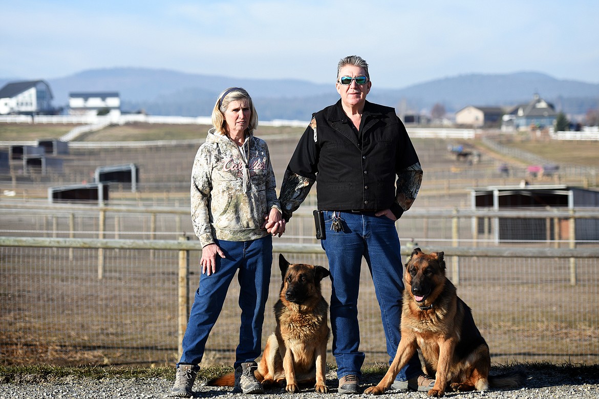 Renee and Randy Downing with their German shepherds Selah and Saber outside Lazy R&amp;R Ranch Supply and Triple Take Arena Boarding &amp; Event Center.