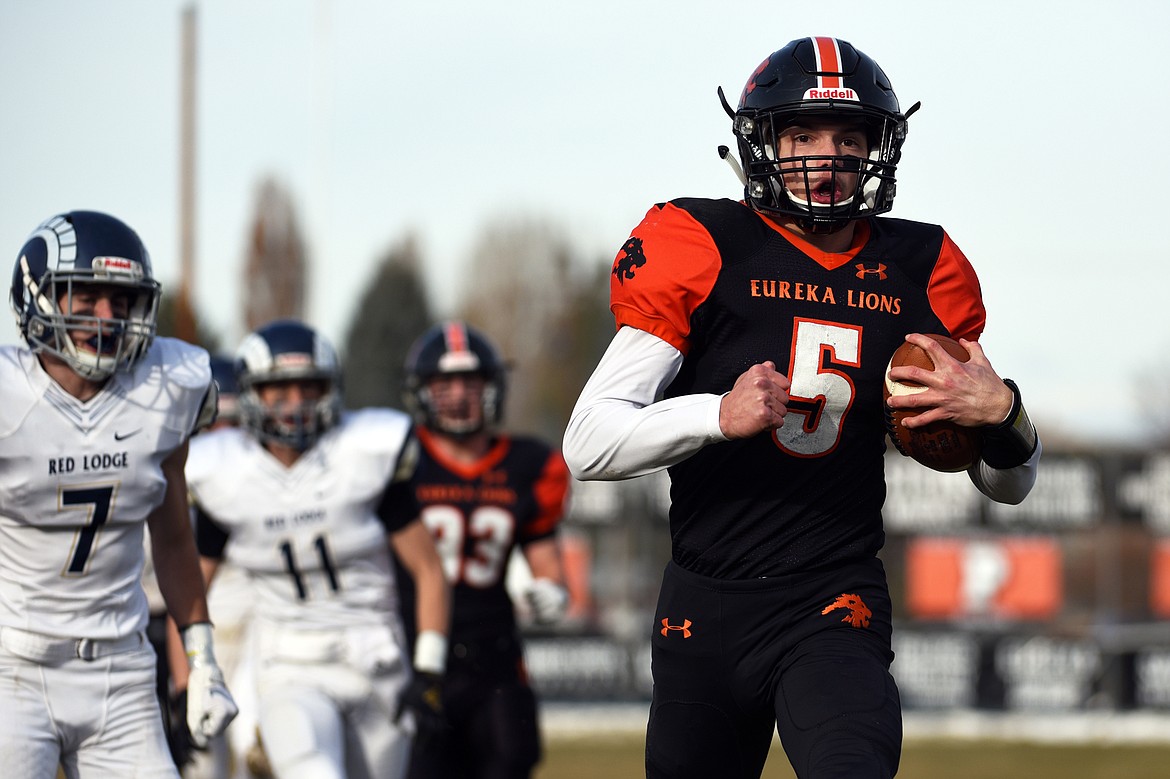 Eureka quarterback Hank Dunn (5) celebrates after a 39-yard touchdown run in the first quarter against Red Lodge in the State Class B semifinal at Lincoln County High School in Eureka on Saturday. Eureka won, 39-35. (Casey Kreider/Daily Inter Lake)