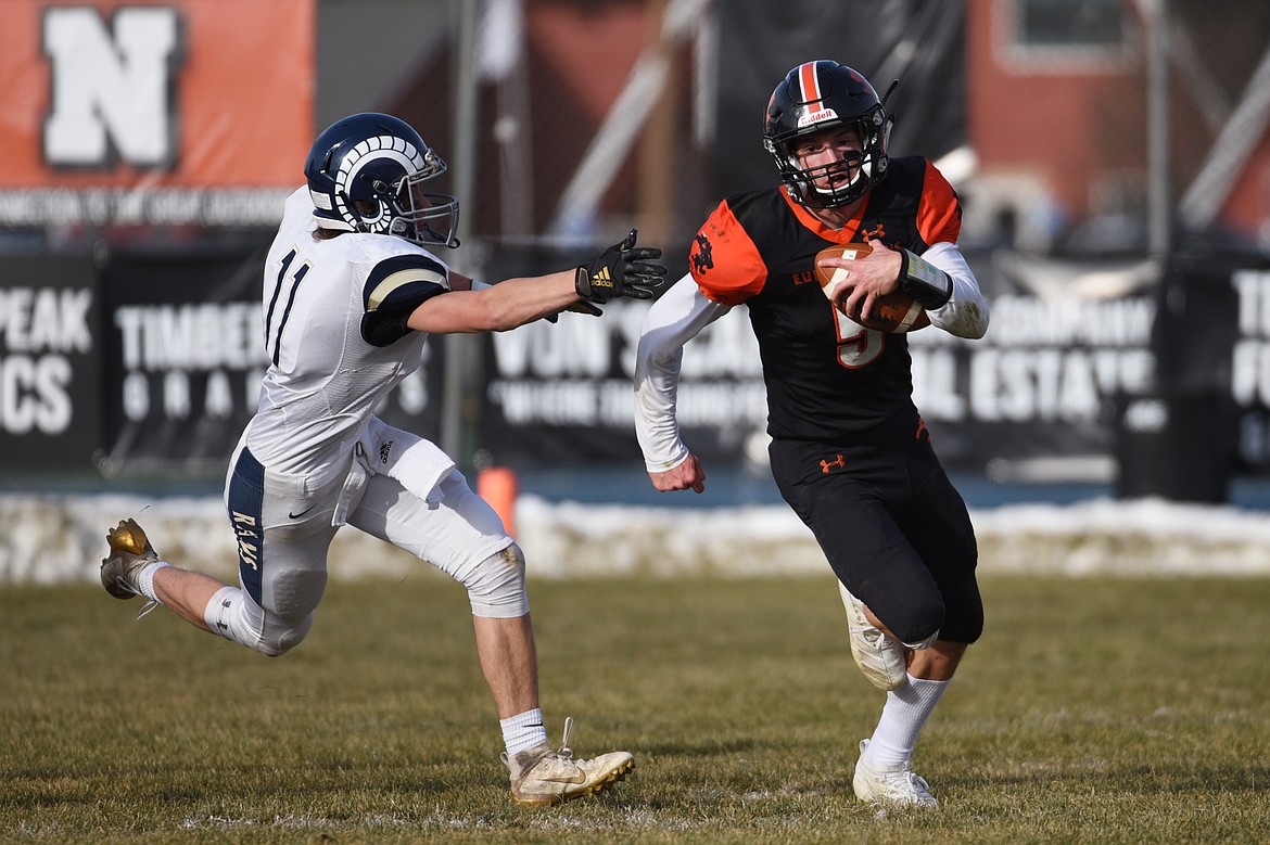 Eureka quarterback Hank Dunn (5) looks for room to run in the first quarter against Red Lodge in the State Class B semifinal at Lincoln County High School in Eureka on Saturday. Eureka won, 39-35. (Casey Kreider/Daily Inter Lake)