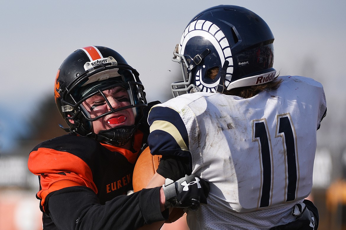 Eureka defensive lineman Chance Muller (66) wraps up Red Lodge wide receiver Braden Tomlin (11) in the second quarter in the State Class B semifinal at Lincoln County High School in Eureka on Saturday. Eureka won, 39-35. (Casey Kreider/Daily Inter Lake)