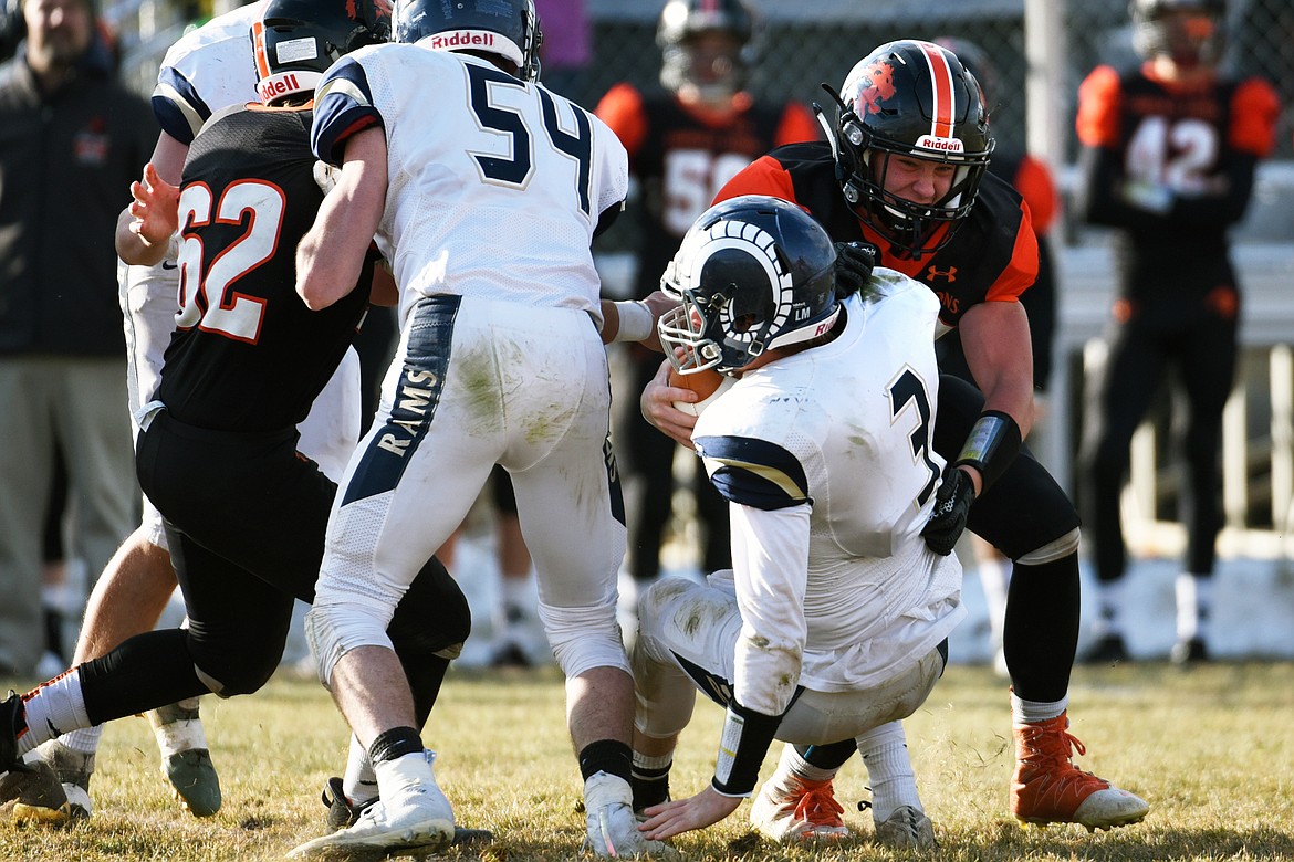 Eureka defensive lineman Johnny Fehr (58) sacks Red Lodge quarterback Austin Heimer (3) in the third quarter in the State Class B semifinal at Lincoln County High School in Eureka on Saturday. Eureka won, 39-35. (Casey Kreider/Daily Inter Lake)