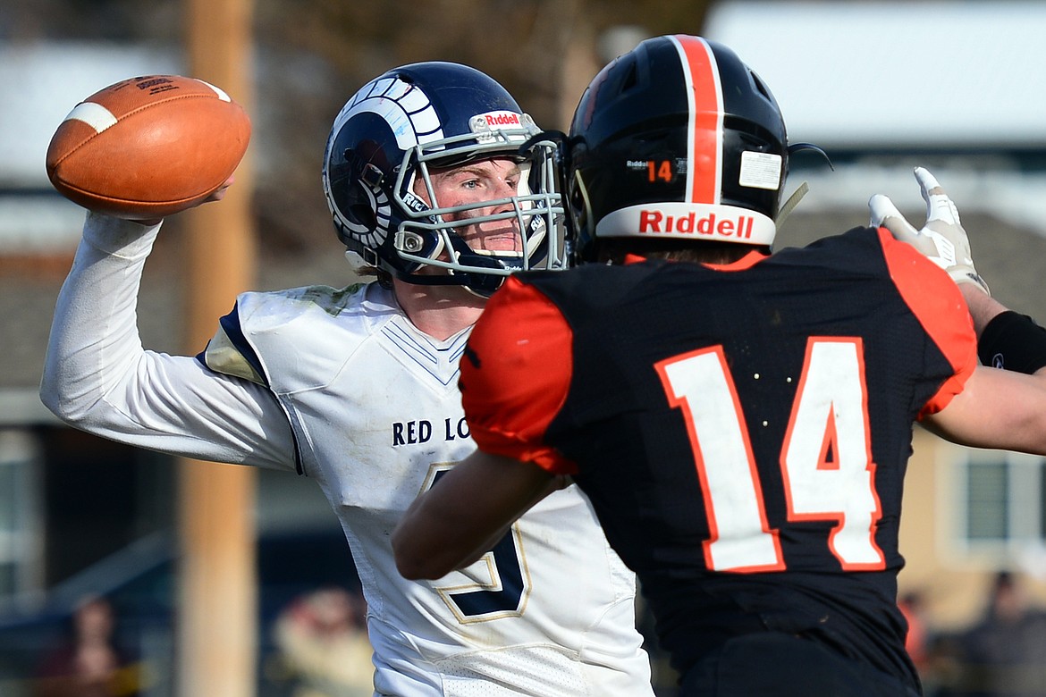 Red Lodge quarterback Austin Heimer (3) looks to throw under pressure from Eureka defensive back Colter Casazza (14) in the State Class B semifinal at Lincoln County High School in Eureka on Saturday. Eureka won, 39-35. (Casey Kreider/Daily Inter Lake)